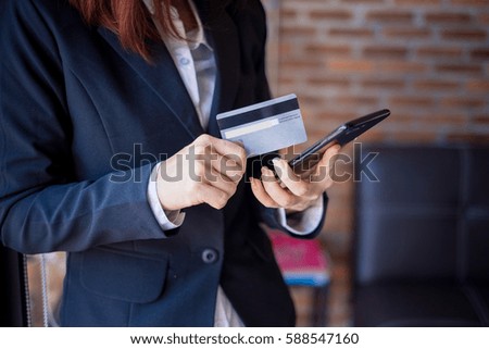 Online payment,Woman's hands holding a credit card and using smart phone for online shopping