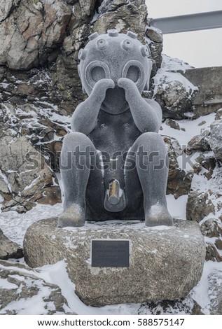 Statue of small man on Jested hill in winter morning
