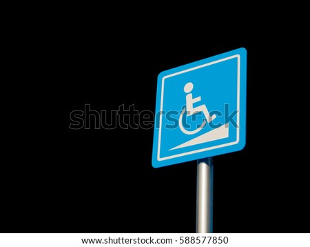 Disabled parking space and wheelchair way sign and symbols on a pole warning motorists isolate on Black background