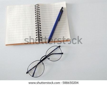 diary and a blue pen. the one glasses for work