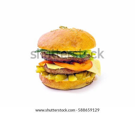 a huge hamburger with tomato and cucumber on white background