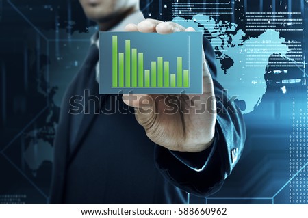 Businessman holding a business card with financial chart on card over visual background