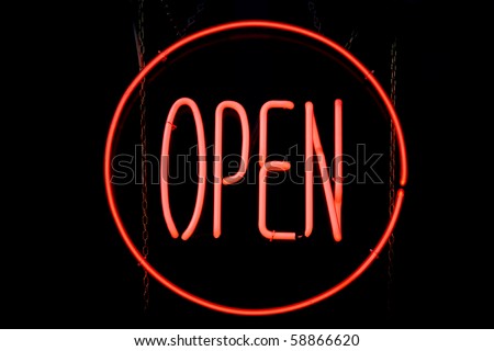 Red neon sign of a circle containing the word 'Open' on a black background.