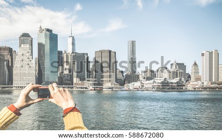 Tourist hands taking pic of New York City skyline from water taxi tour on river Hudson with digital pocket camera - Wanderlust concept and travel lifestyle around the world - Retro contrasted filter