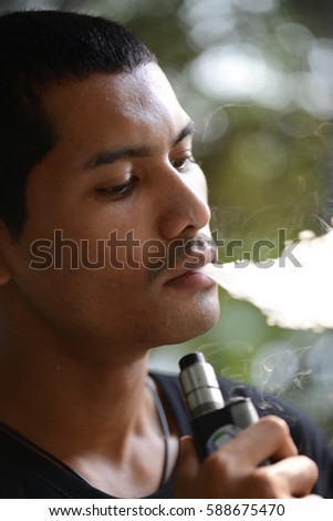 Young man smoking electronic cigarette
