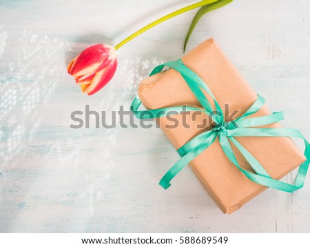 Gift box with green ribbon on pastel spring background. Copy space top view father's mother woman day Easter special occasion present