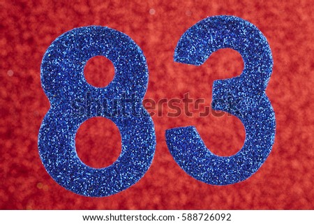 Number eighty-three blue color over a red background. 
