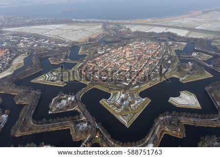 Aerial view of the fortified city of Naarden Vesting, Holland in winter time with snow. Star fortifications were developed in the late fifteenth centuries.