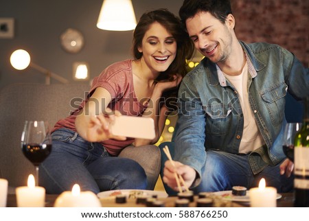 Couple enjoying sushi together at home interior 