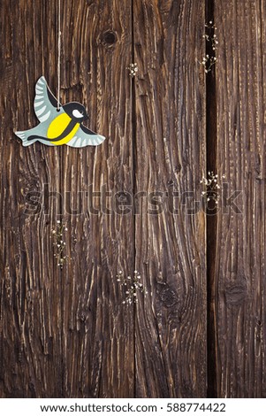 Bird decoration hanging on rope on old wooden background with wood copy space