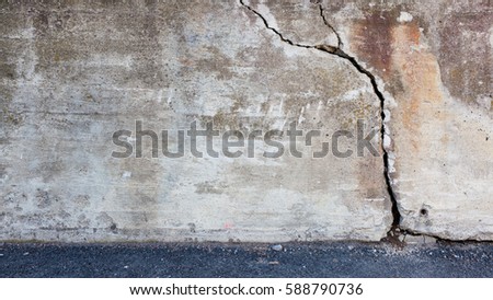 Big crack in old messy concrete wall Royalty-Free Stock Photo #588790736