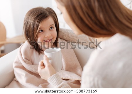 Cheerful little girl recovering from flu Royalty-Free Stock Photo #588793169