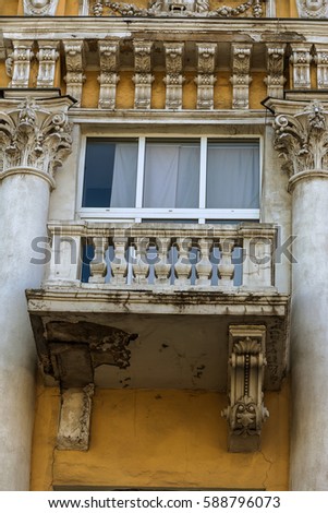 ODESSA, UKRAINE - Ruined facade of historic building. Destroyed monuments. Old facade. Architectural detail of damage to outside of facade of castle. Old doors, windows, balconies, columns. moldings