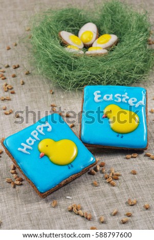 Square cakes with a picture of chickens on a blue background and the words Happy Easter next to the jack, which are cakes with a picture of fried eggs