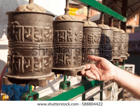 Prayer wheels and a hand 