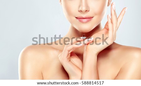 Beautiful Young Woman with Clean Fresh Skin  touch own face . Facial  treatment   . Cosmetology , beauty  and spa . Royalty-Free Stock Photo #588814517
