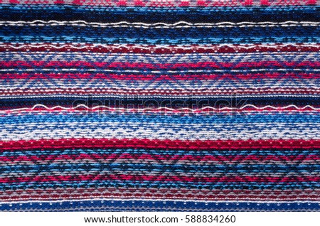 Background of colored wool knit with nordic patterns wrong side .