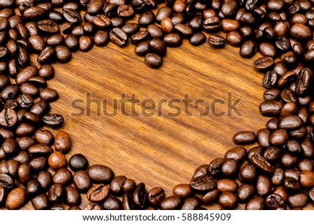 heart coffee beans frame and wooden background textures.
