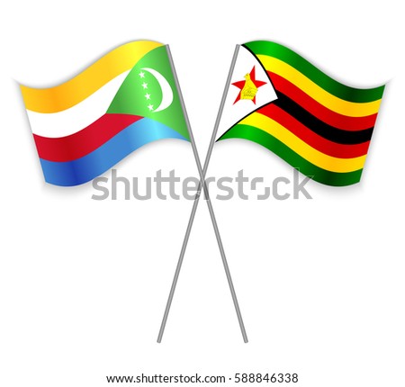 Comoran and Zimbabwean crossed flags. Comoros combined with Zimbabwe isolated on white. Language learning, international business or travel concept.