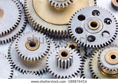 metal cogwheels for machinery on industrial scratched background