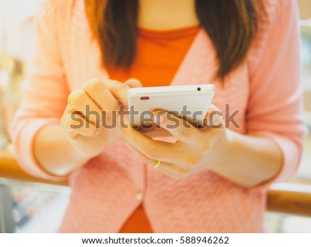 Pretty Young woman using smart phone. Female working on cell phone in big shopping mall