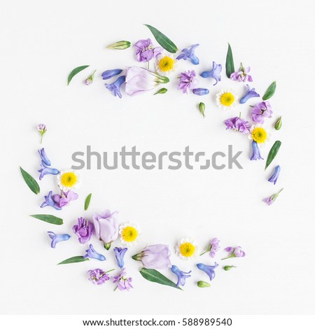 Flowers composition. Wreath made of various colorful flowers on white background. Easter, spring, summer concept. Flat lay, top view, copy space Royalty-Free Stock Photo #588989540