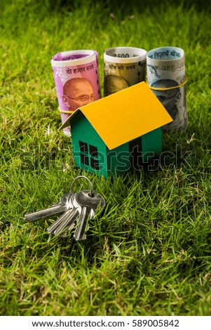 Indian Real estate business concept showing 3D model house with keys, paper currency notes and Calculator. Selective focus