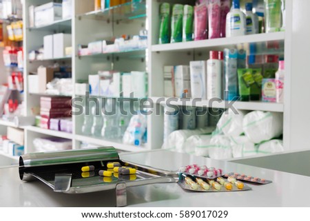 Drug prescription for treatment medication. Pharmaceutical medicament, cure in container for health with counter store table pharmacy background  Royalty-Free Stock Photo #589017029