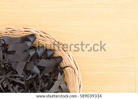 black ribbon on wood background.