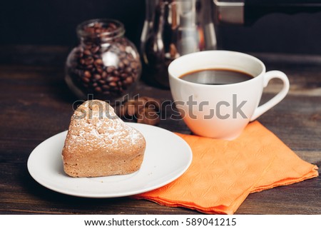 Chocolate cookies on a plate, orange cloth, Turk for coffee, white mug.
