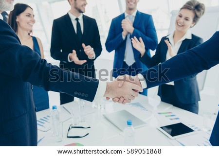 Close up of two business partners shaking hands  for signed contract.