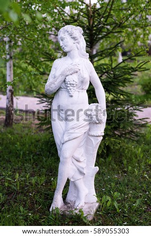 Statue in the garden, woman with grape