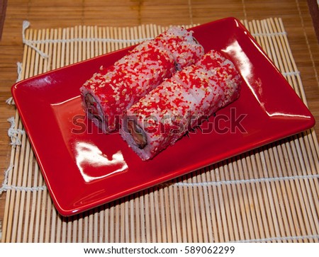rolls with salmon. serving on the red plate