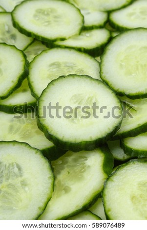 Cucumber slices as background. Green fresh cucumbers as background. Cucumber pattern texture. Vegetable food photo.