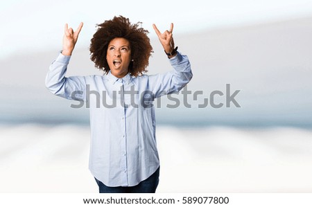 young black woman doing rock gesture