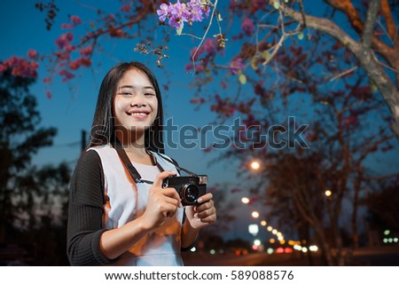 Female photographer with lifestyle photographer taking pictures, film camera