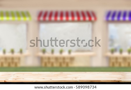 wooden table in Small Shop and business design Image Blurred  background