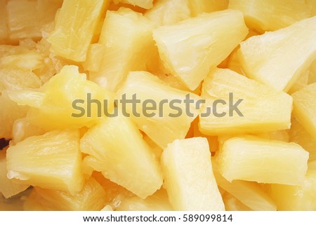 Pineapple slices as background. Yellow pineapples texture pattern.