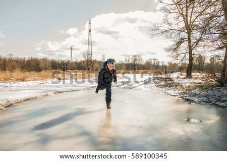 happy child falling on the ice