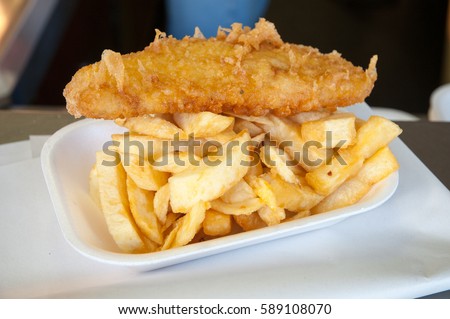 Battered cod and chips in chip shop, England, UK Royalty-Free Stock Photo #589108070