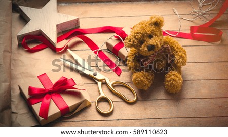 cute gift, star shaped toy, teddy bear and things for wrapping on the wonderful wooden brown background