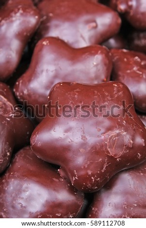 Gingerbread. Chocolate coated gingerbreads as background. Flower shaped gingerbread texture pattern. Cake texture. Cake background