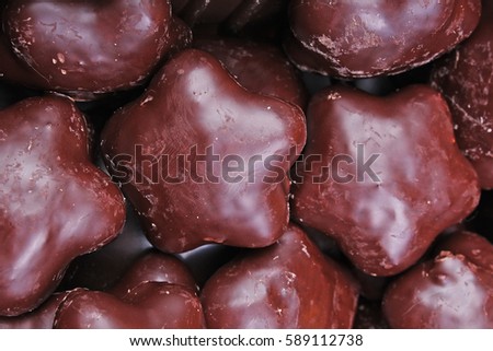 Gingerbread. Chocolate coated gingerbreads as background. Flower shaped gingerbread texture pattern. Cake texture. Cake background