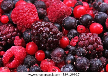 Frozen mixed berries as background. Blueberries,raspberries black berries and currant mulberry texture pattern