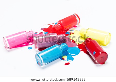 Image of bright-colored nail polish spilling from bottles
