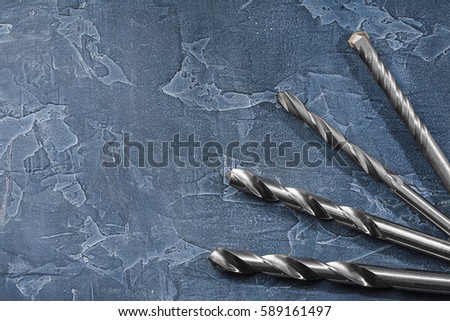 workplace on a dark stone with drill bit