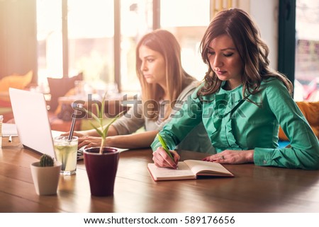 Female coworkers working together