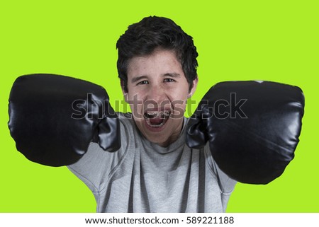 Young crazy boy with boxing gloves. Joking pose