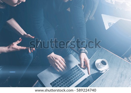 Group of two coworkers making great brainstorming during work process in modern loft.Young bearded man using laptop.Business people meeting concept.Horizontal, visual effects