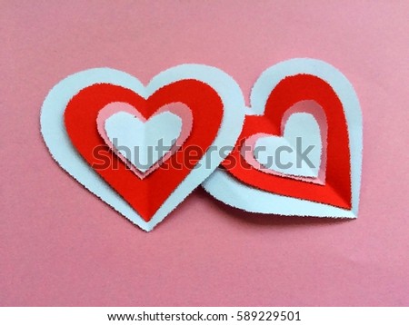 Two hearts isolate on pink texture background 